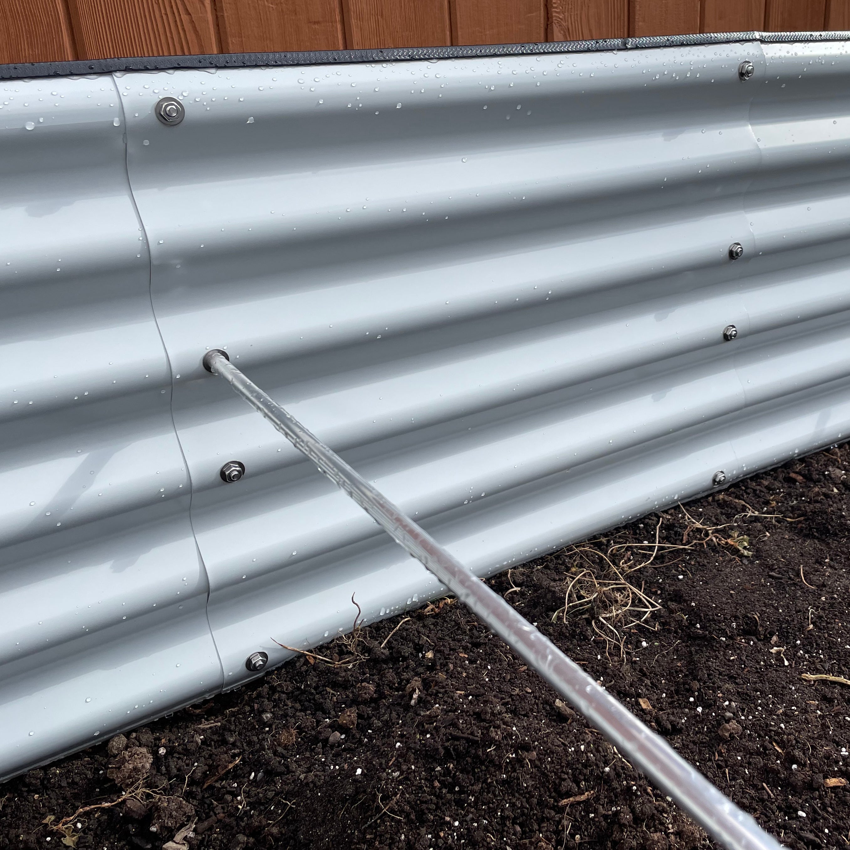 Close-up of aluminum bracing rod connection point with bolt and washer